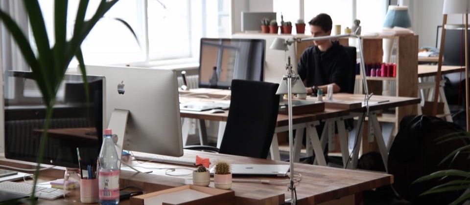The offices of a small company, with desks and screens