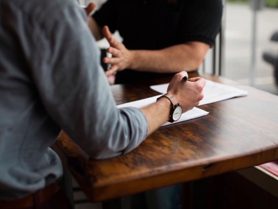 Two people going through a document at a table
